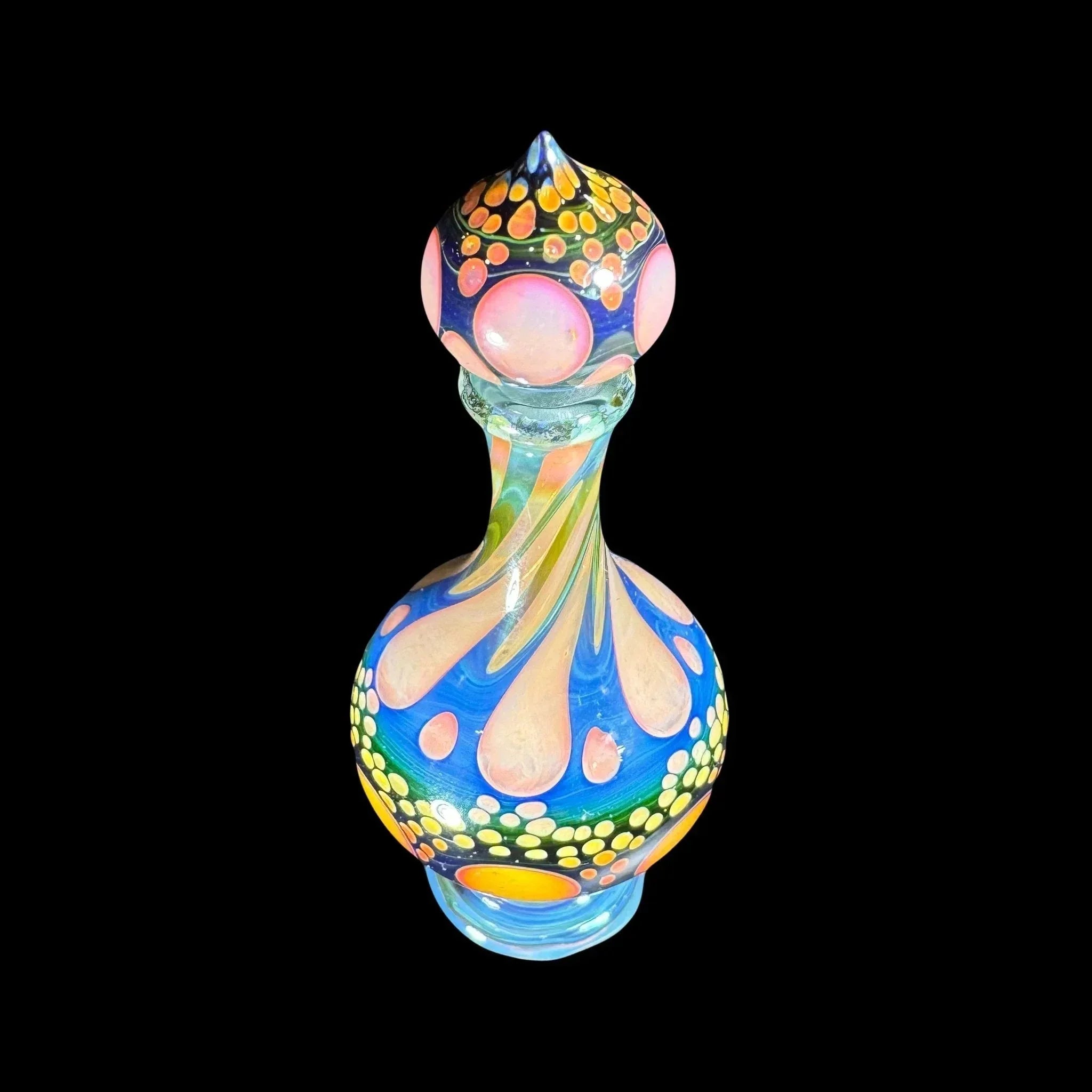 Colorful heady glass art bottle with swirling patterns and dotted accents on a black background