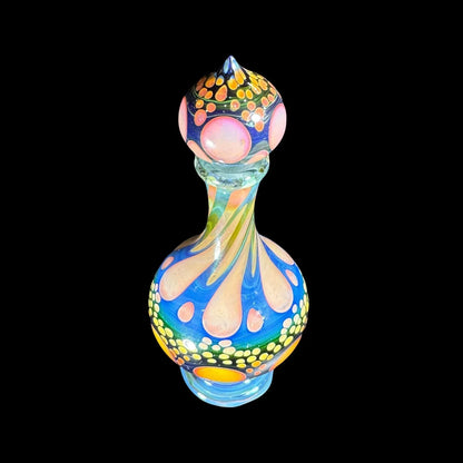 Colorful heady glass art bottle with swirling patterns and dotted accents on a black background
