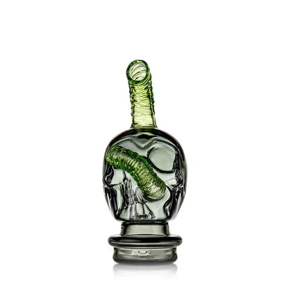 Green glass skull-shaped smoking accessory with spiral tube design, isolated on white background