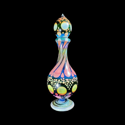 Colorful heady glass art bottle with swirling patterns and dot accents on black background