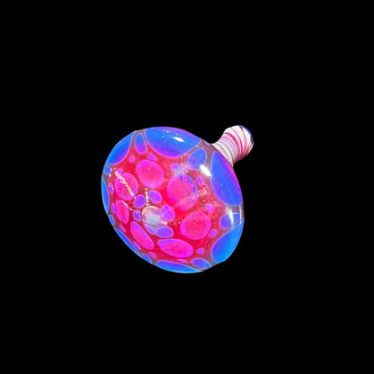 Colorful glass carb cap with vibrant pink and blue bubble pattern on black background