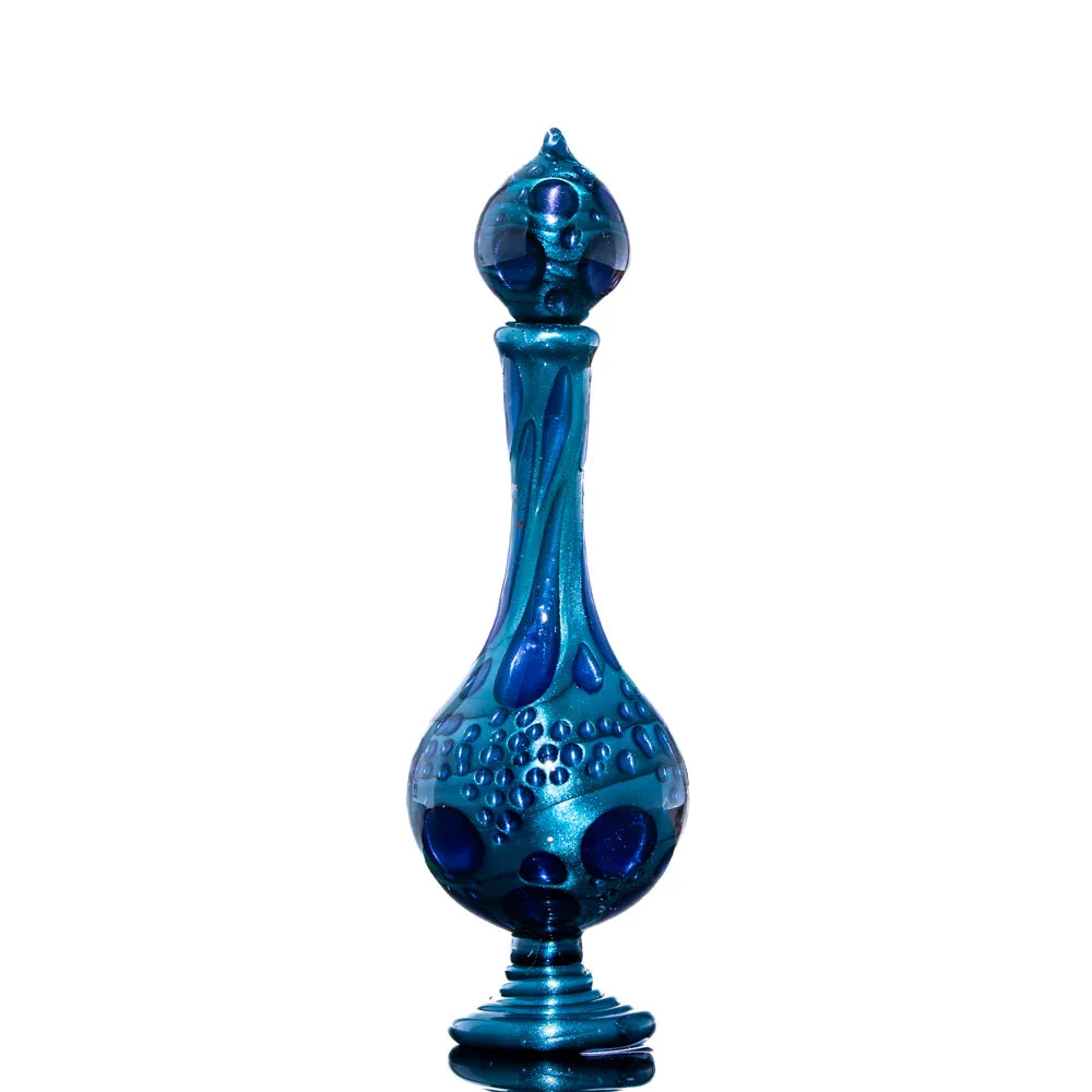 Handcrafted blue glass art bottle with textured patterns on white background
