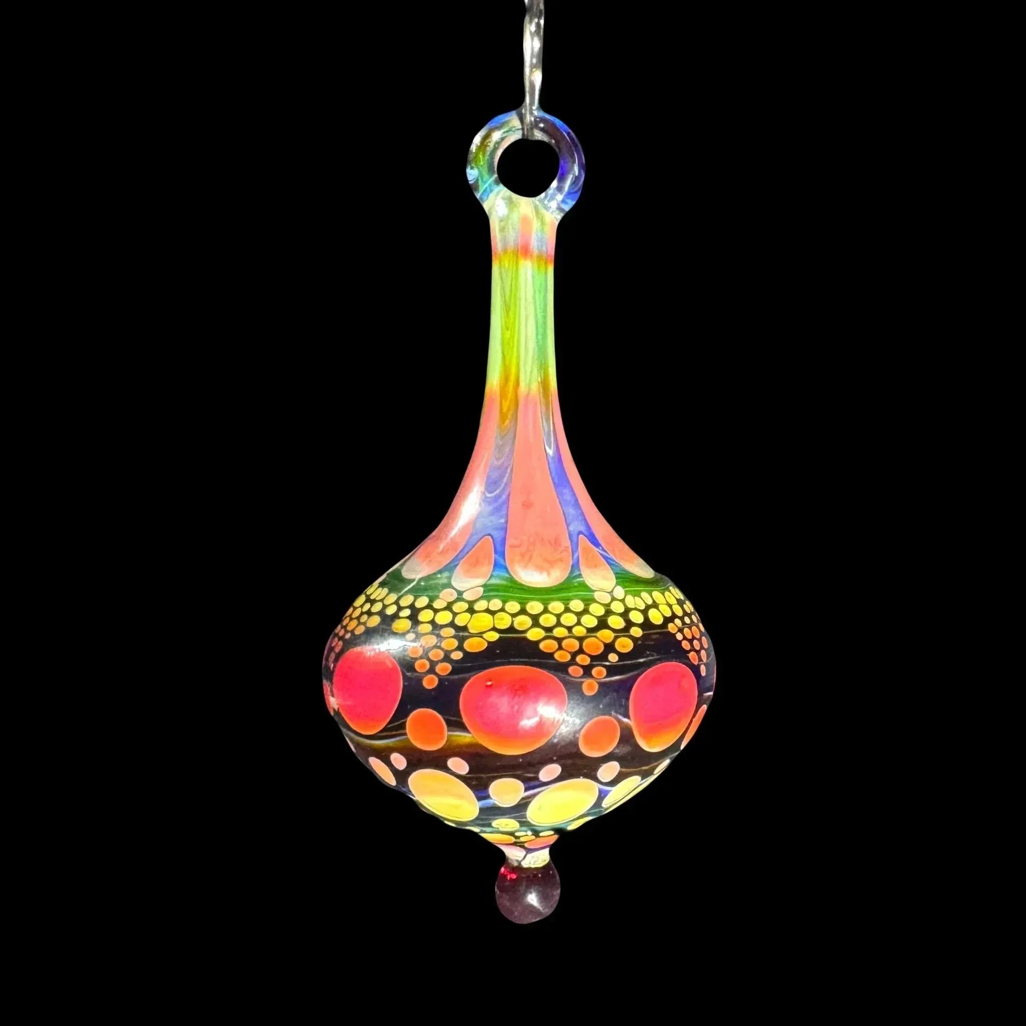 Colorful hand-blown glass pendant with vibrant rainbow patterns and dot accents on black background