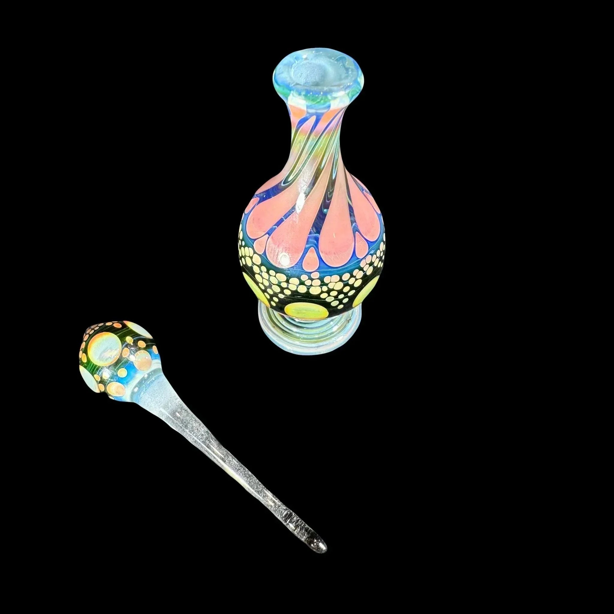 Colorful heady glass jar and dabber set with intricate patterns on black background