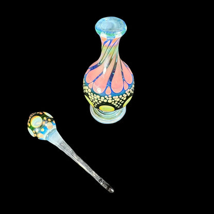 Colorful heady glass jar and dabber set with intricate patterns on black background