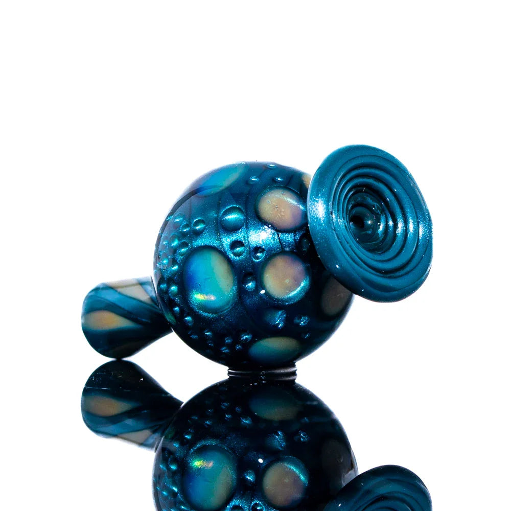 Iridescent blue glass hand pipe with bubble texture and spiral bowl, displayed on a reflective surface