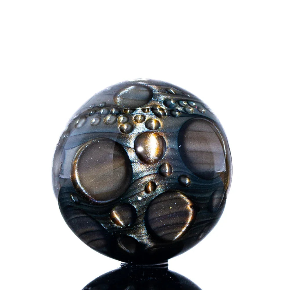 Hand-blown glass marble with metallic, cratered design, heady glass art accessory