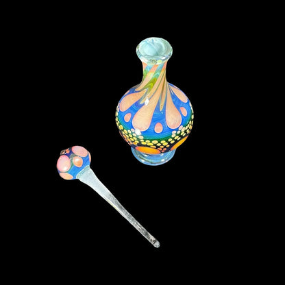 Colorful heady glass decanter and matching wand with vibrant swirl and dot patterns on black