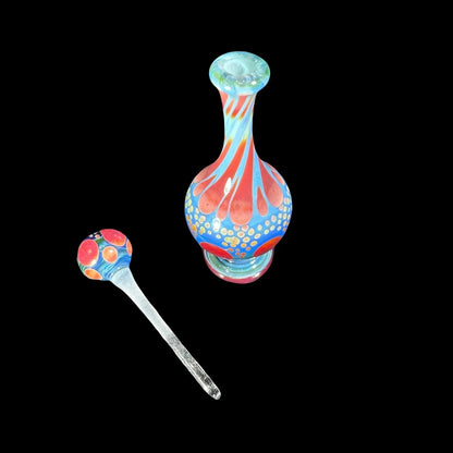 Colorful hand-blown glass decanter with matching stopper, swirling red and blue design