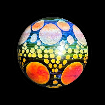 Heady glass marble with colorful cosmic pattern and vibrant orb designs on black background