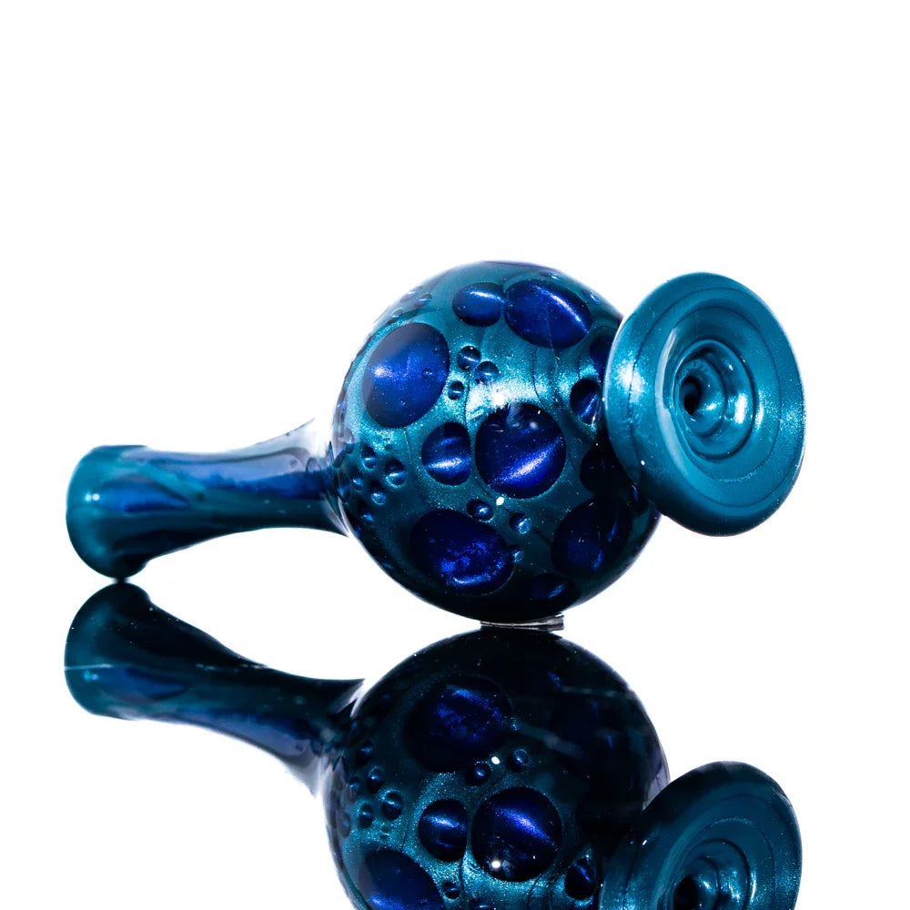 Blue glass hand pipe with bubble texture, reflective surface, artisan smoking accessory