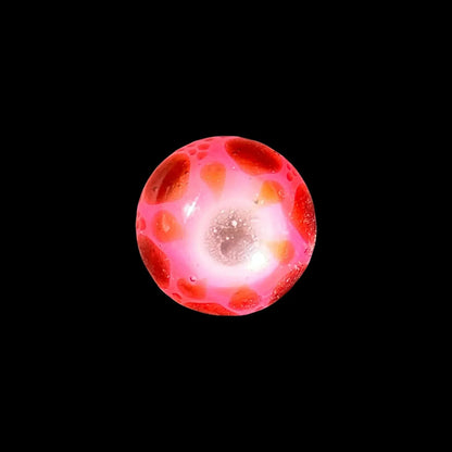 Pink and red glass carb cap marble with bubble accents on black background