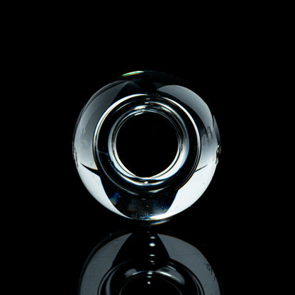 Toroidal clear glass marble on black background, heady glass accessory