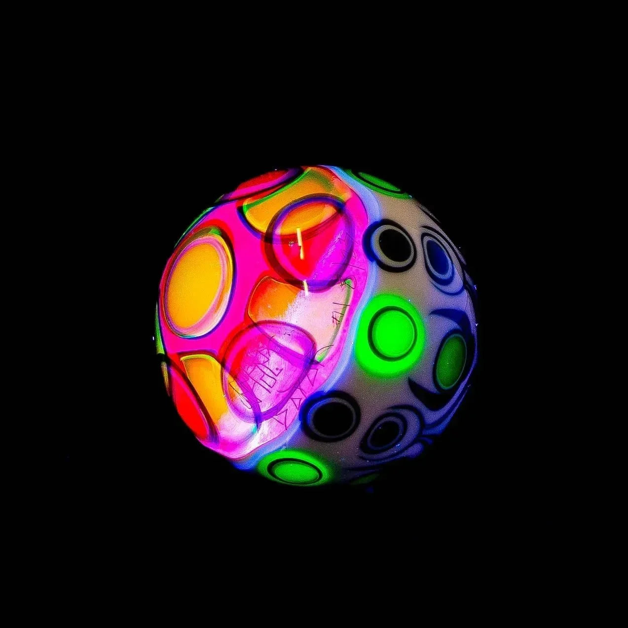 Colorful glass sphere with glowing neon circles and black background