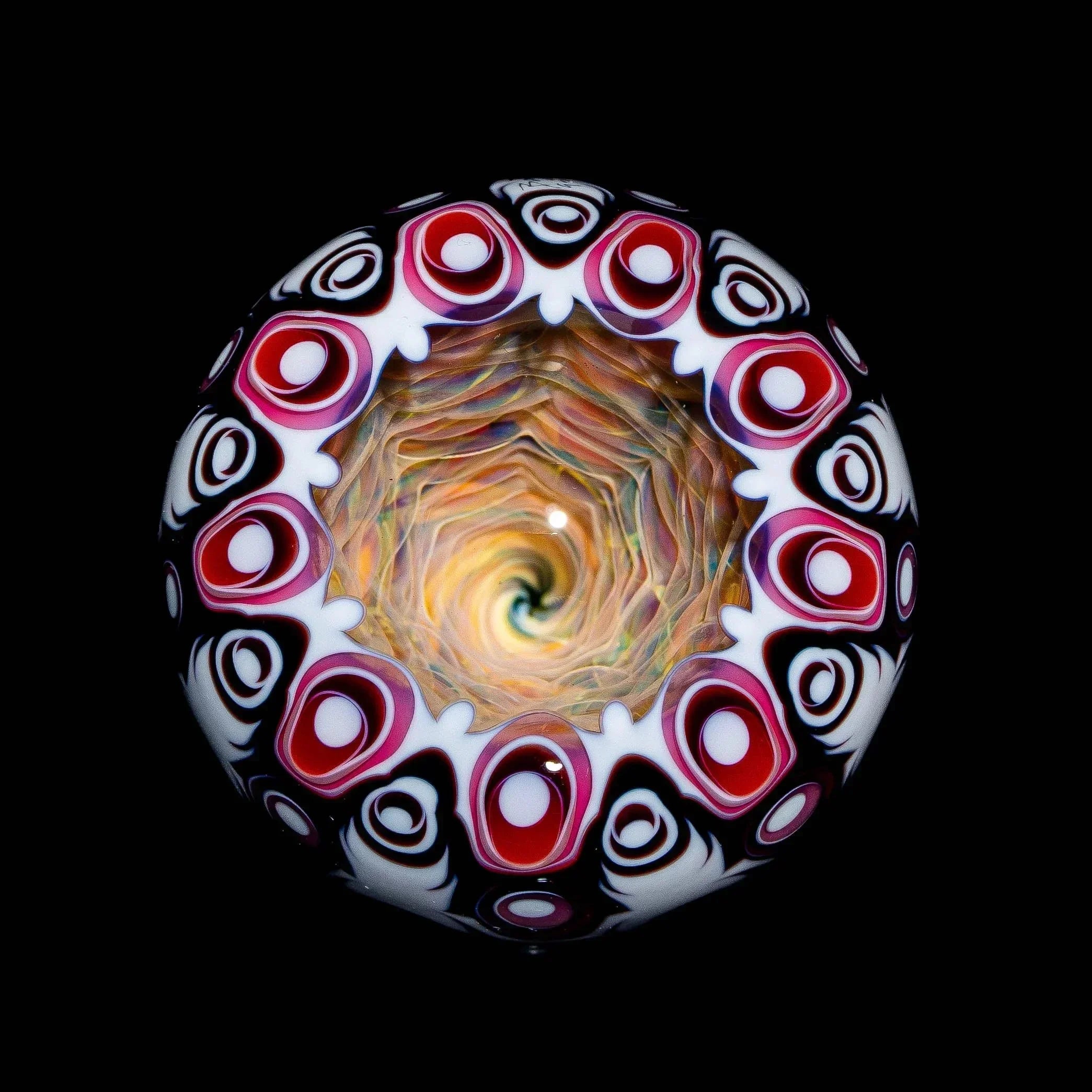 Colorful heady glass marble with psychedelic spiral and red, white, and black patterns