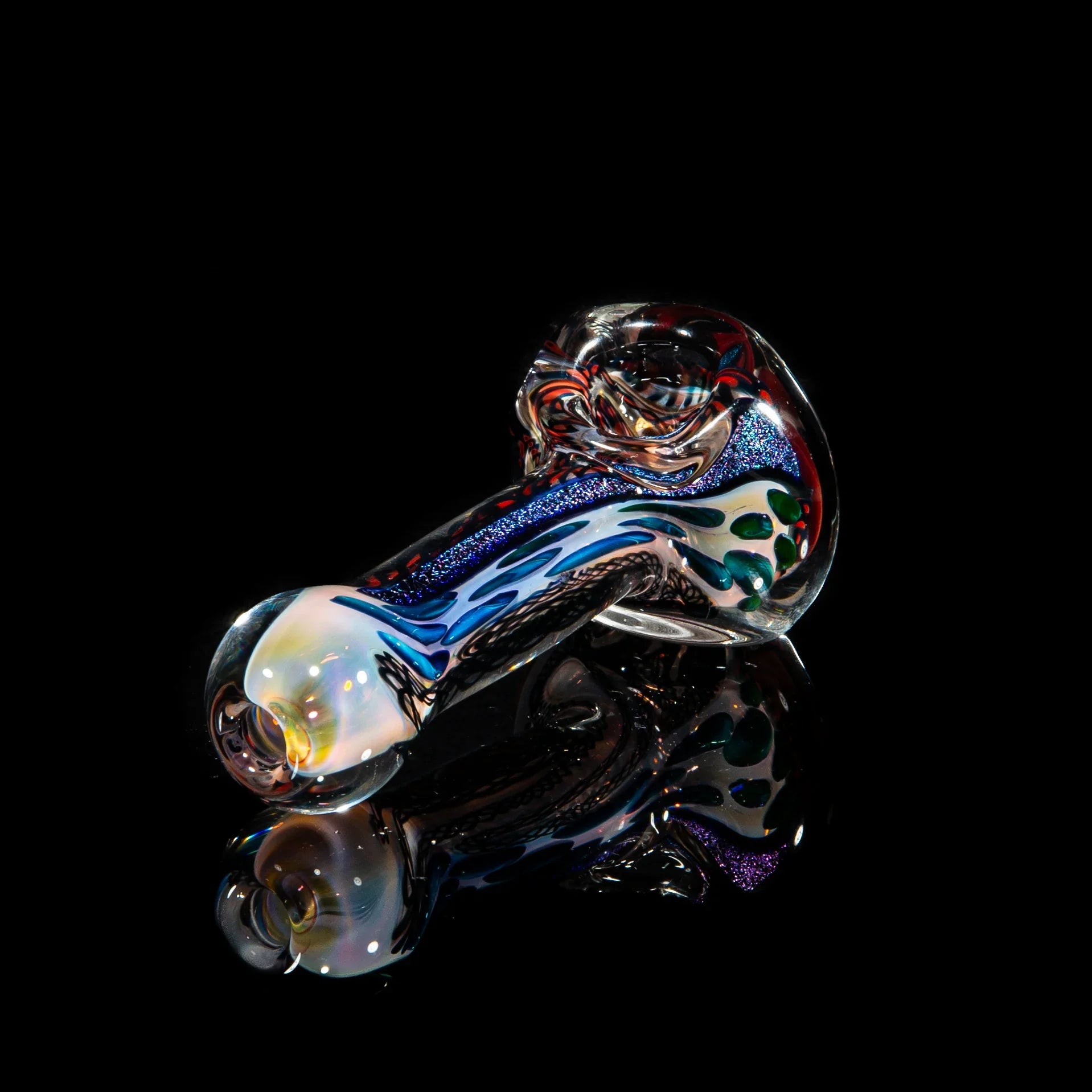 Hand-blown glass pipe with blue, brown, and iridescent accents on a black background