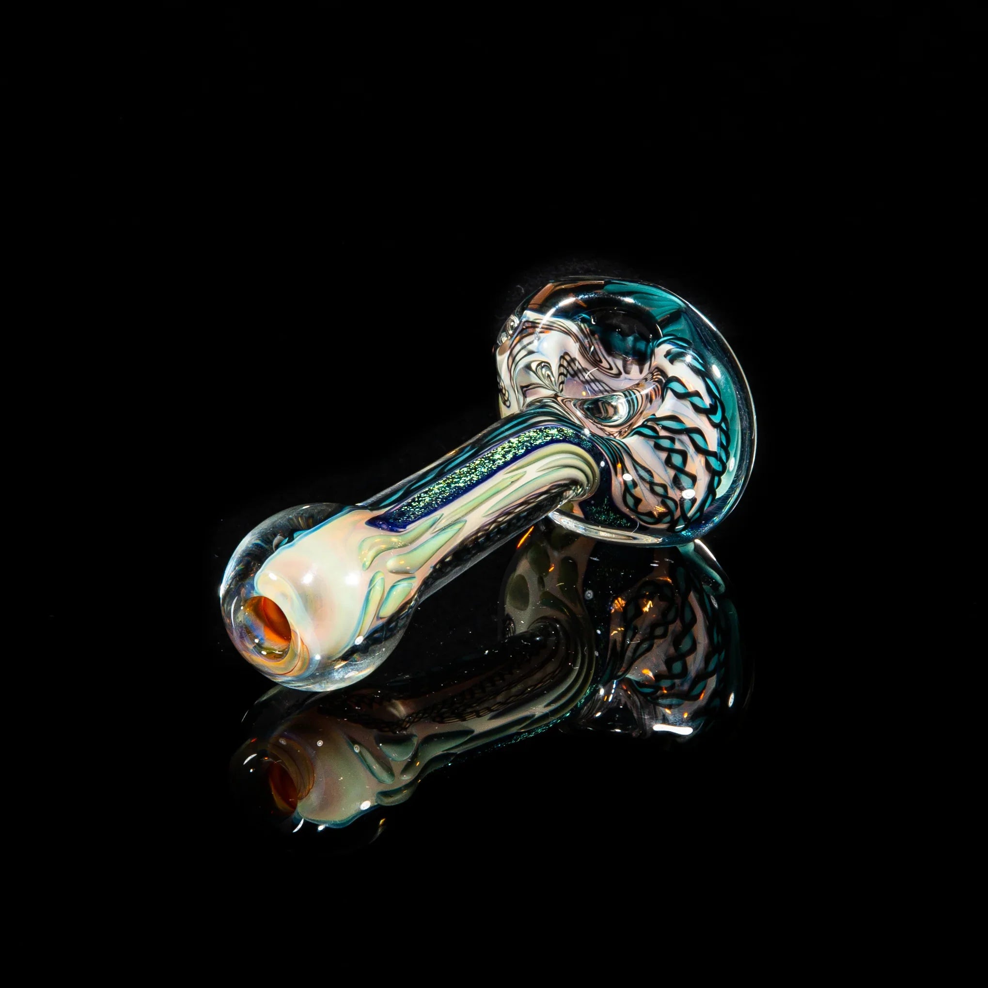 Handcrafted glass spoon pipe with teal green dichroic strip and swirling patterns on black background