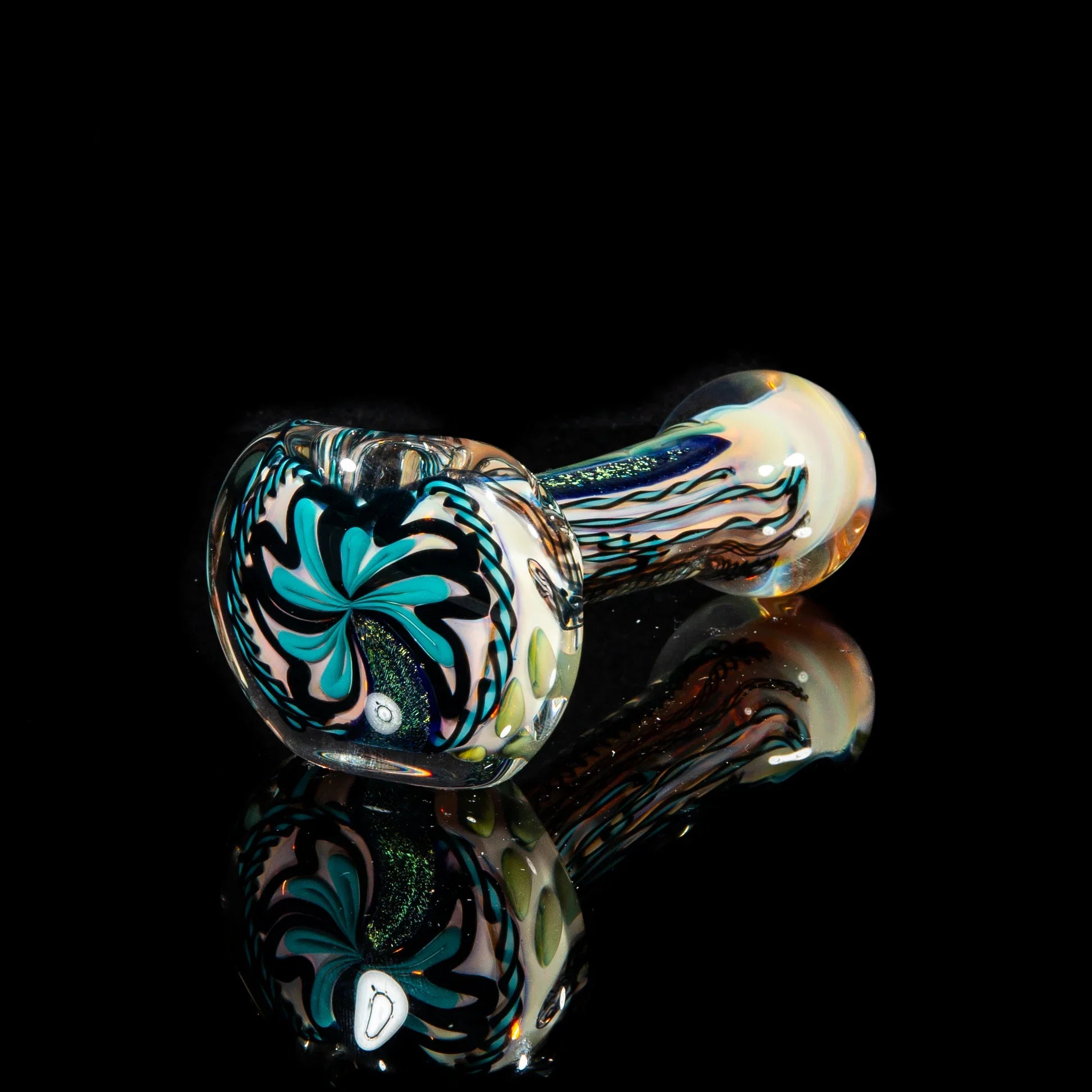 Teal and green artistic glass pipe with dichroic swirl design on black background