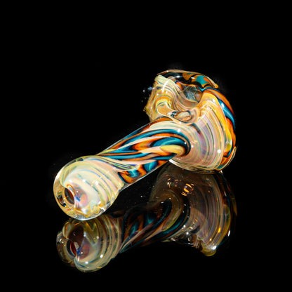 Hand-blown glass pipe with yellow, teal, and orange swirls on a black background