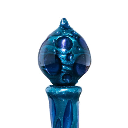 Close-up of a blue glass art pipe with textured, orb-shaped bowl and shiny finish