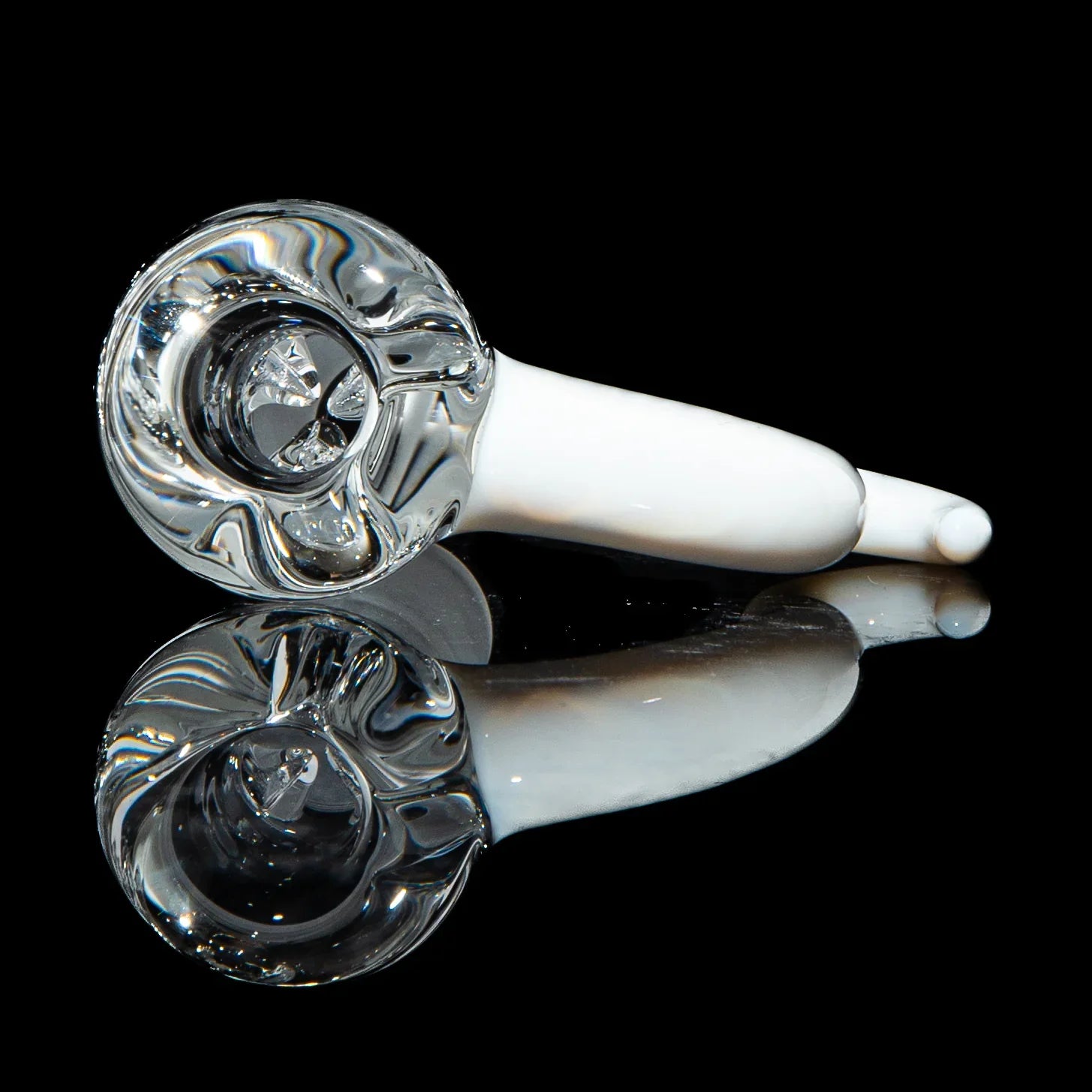 Clear and white glass hand pipe with pinch slide, displayed on a reflective black surface.