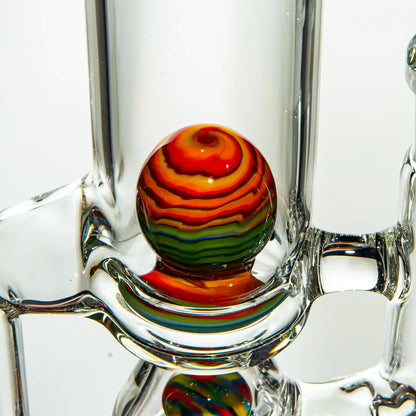 Close-up of a heady glass water pipe with a vibrant rainbow swirl marble accent.