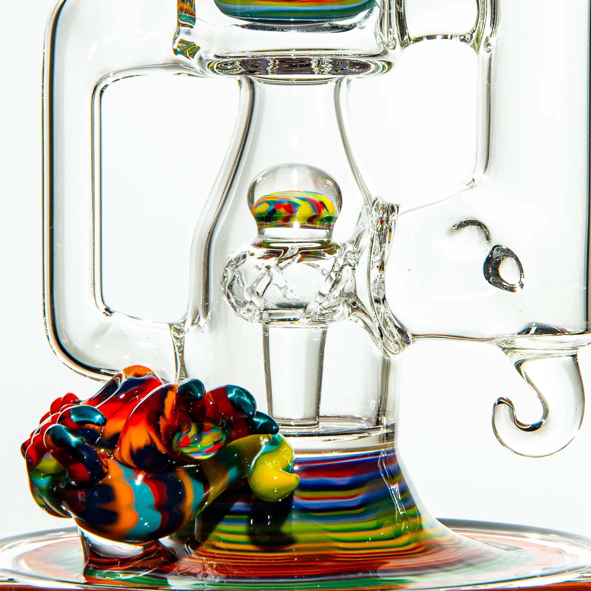 Heady glass water pipe with vibrant rainbow accents and intricate clear glasswork