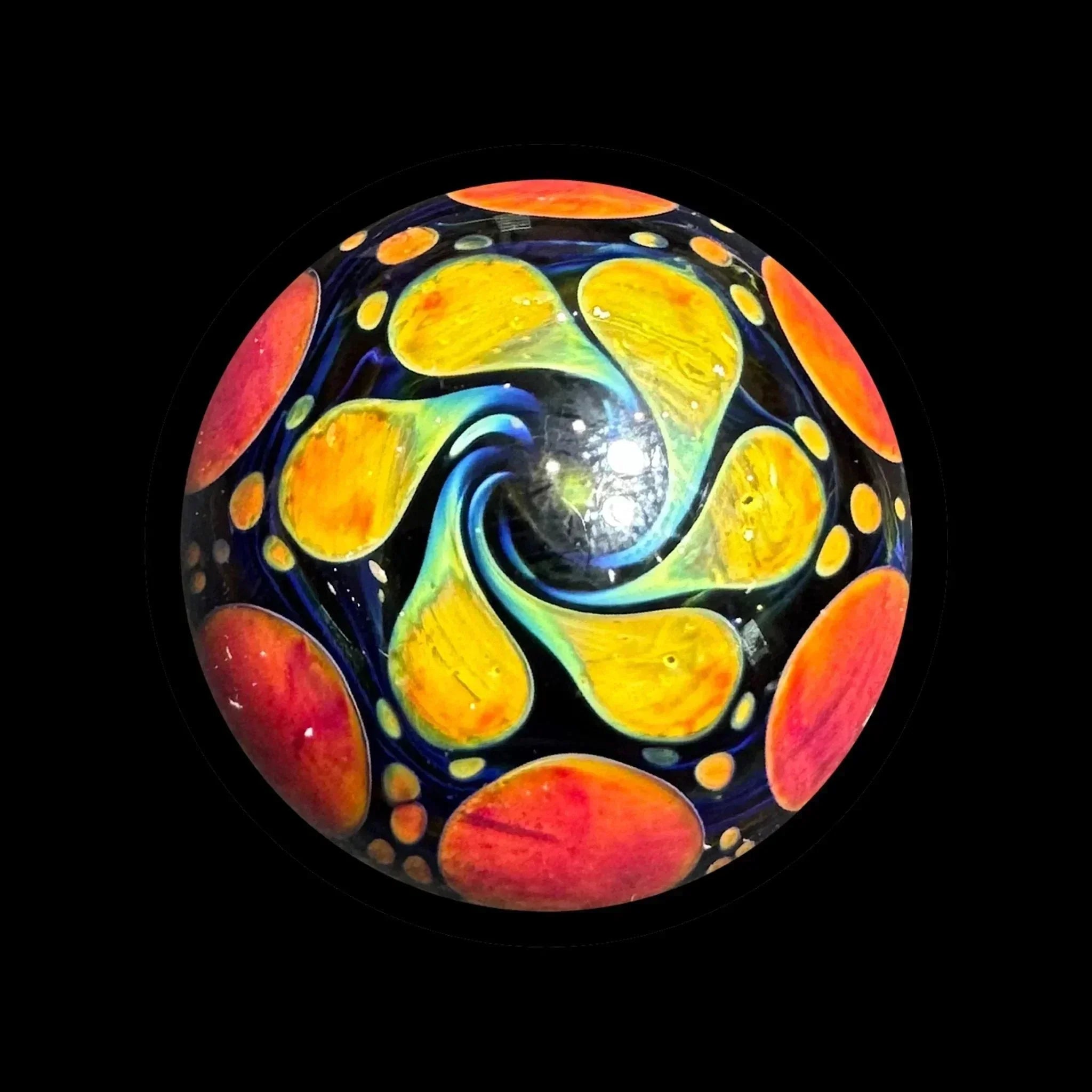 Hand-blown glass marble with vibrant yellow, orange, and blue psychedelic swirl design