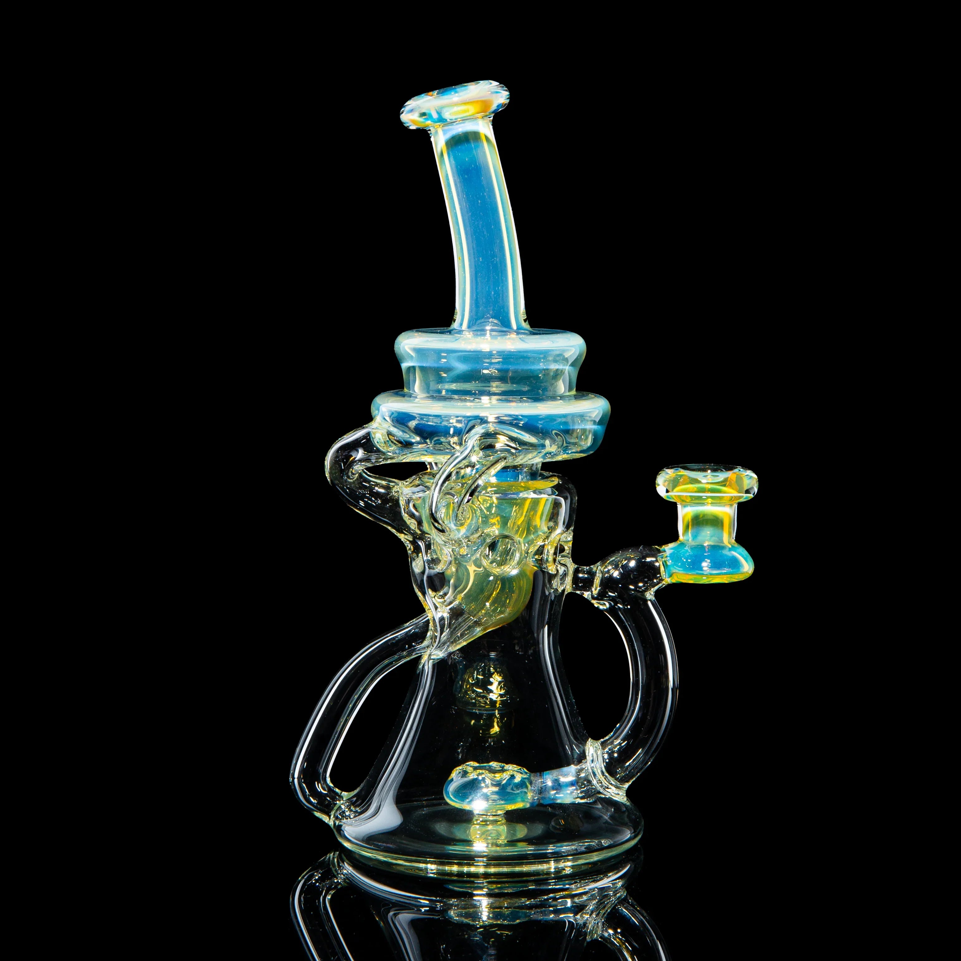 Heady glass water pipe with blue and yellow accents against a black background