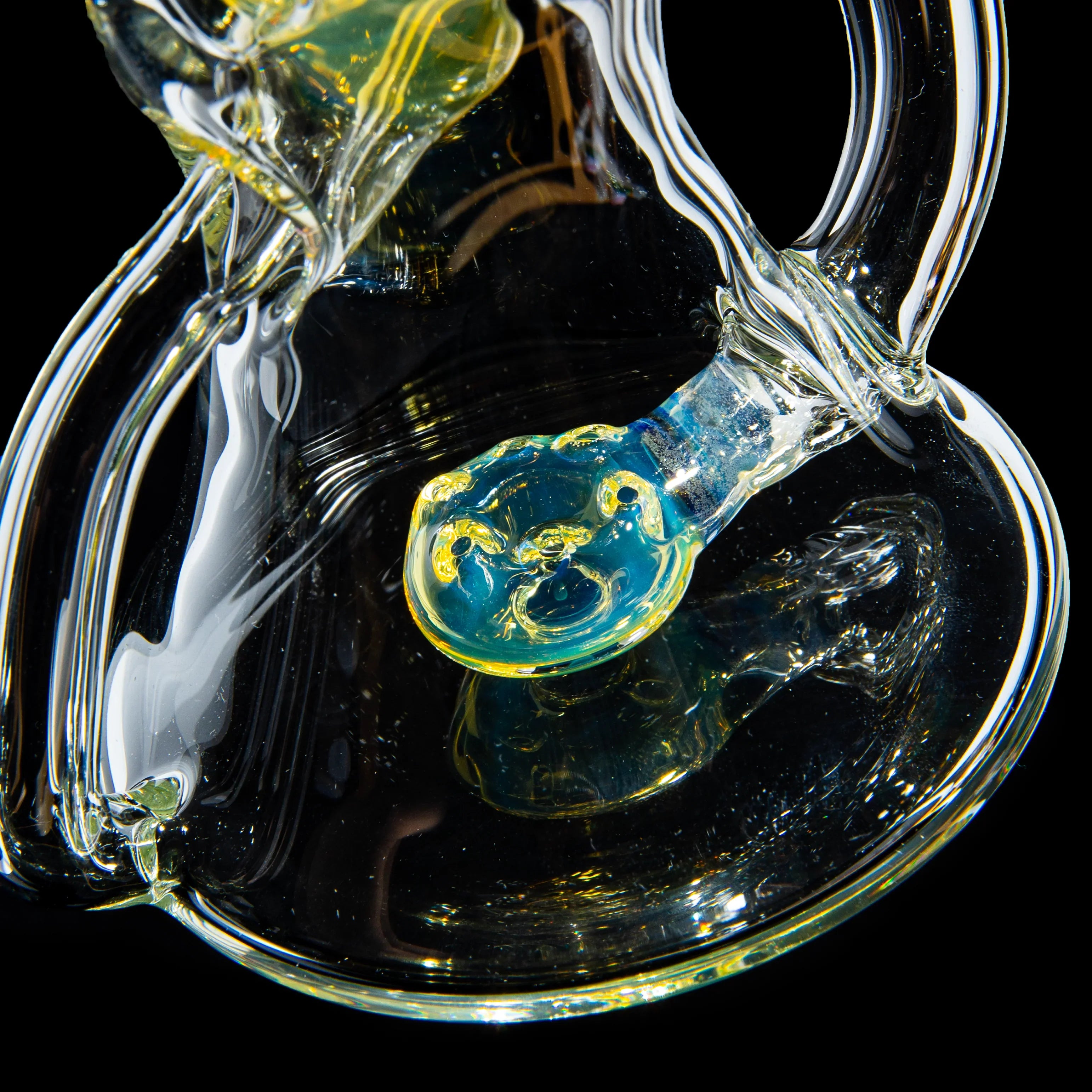Close-up of intricate, colorful glass water pipe detail on black background
