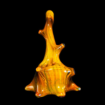 Hand-blown glass art sculpture in amber and yellow tones on a black background