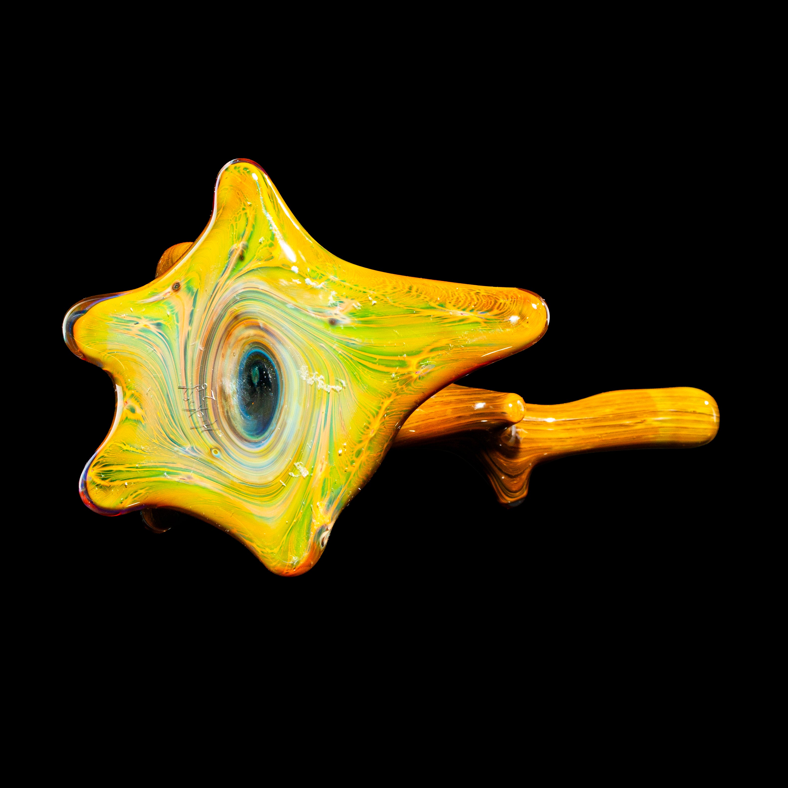 Heady glass hand pipe with yellow swirled design and unique artistic shape on black background
