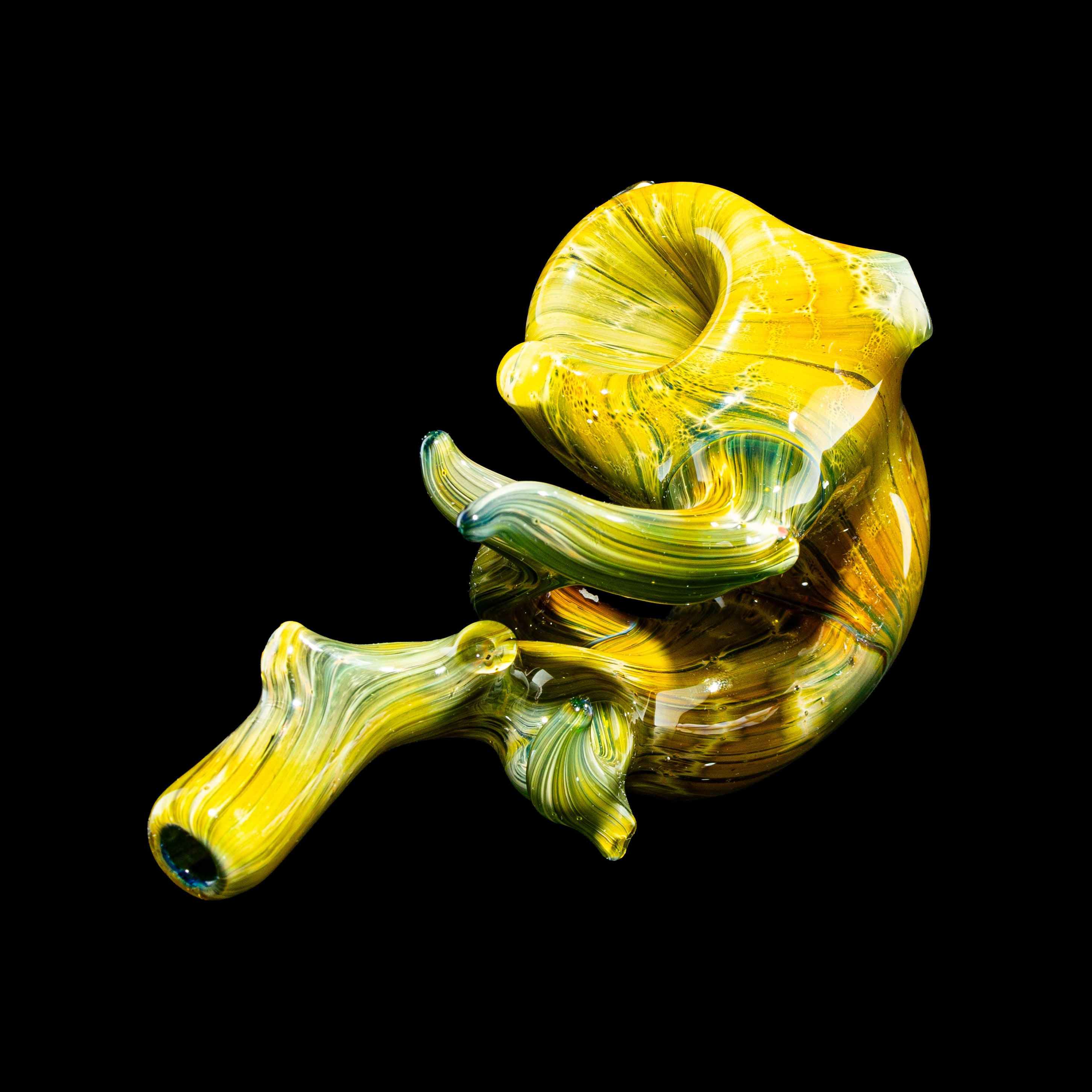 Heady yellow and green glass hand pipe with unique swirling design on black background