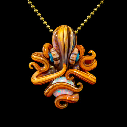 Handcrafted glass octopus pendant with orange tentacles and opal detail on a gold chain