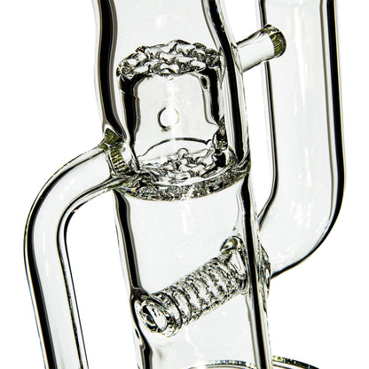 Close-up of clear glass water pipe with intricate percolator and coiled glass detail