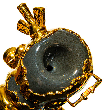 Close-up of luxury heady glass pipe with gold accents and intricate textured details
