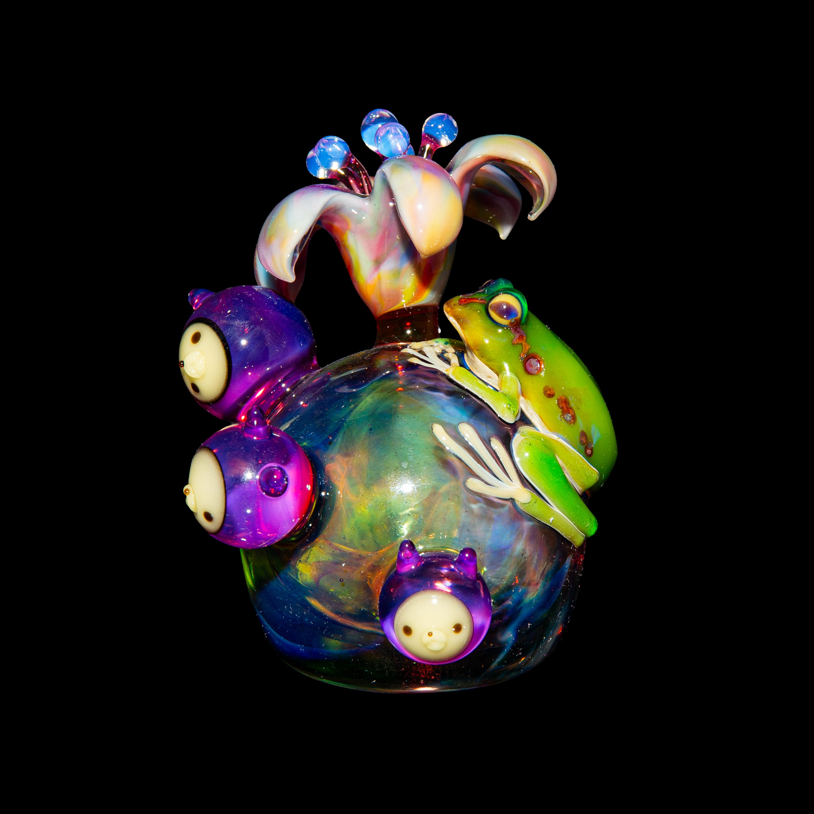 Colorful heady glass art piece with flower top, cartoon faces, and a green frog detail
