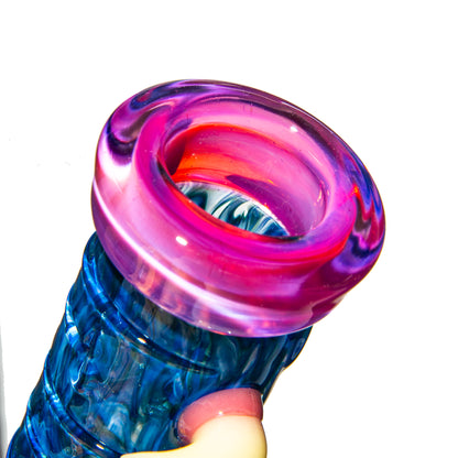 Colorful artisan glass pipe featuring a vibrant pink and blue mouthpiece close-up