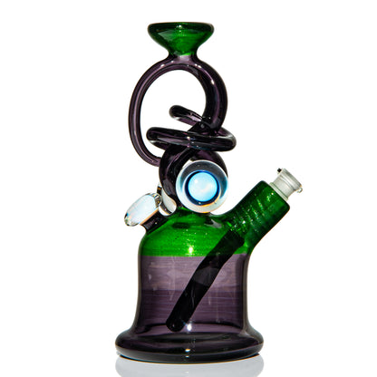 Heady glass rig with green and purple swirled design, artistic glass eye accents