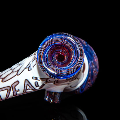 Glass hand pipe with blue, red, and white spiral design on black background