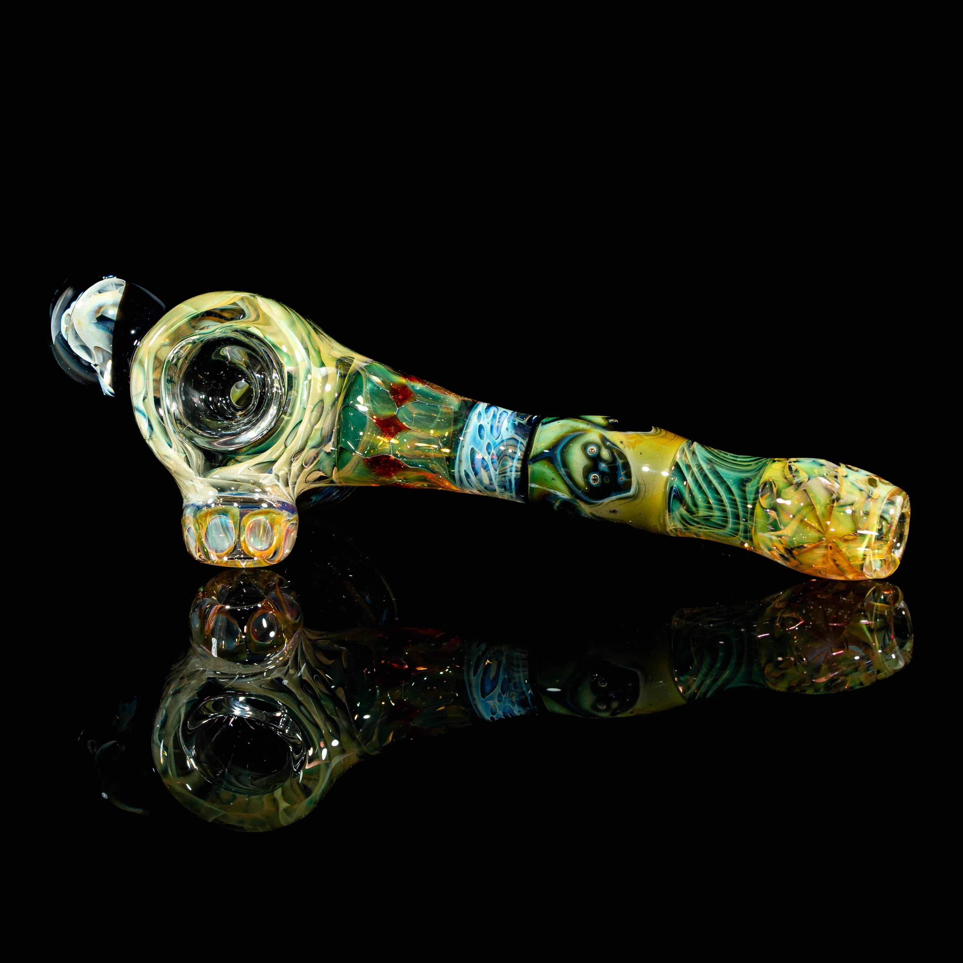 Heady glass hand pipe with colorful patterns and unique artwork, displayed on black background