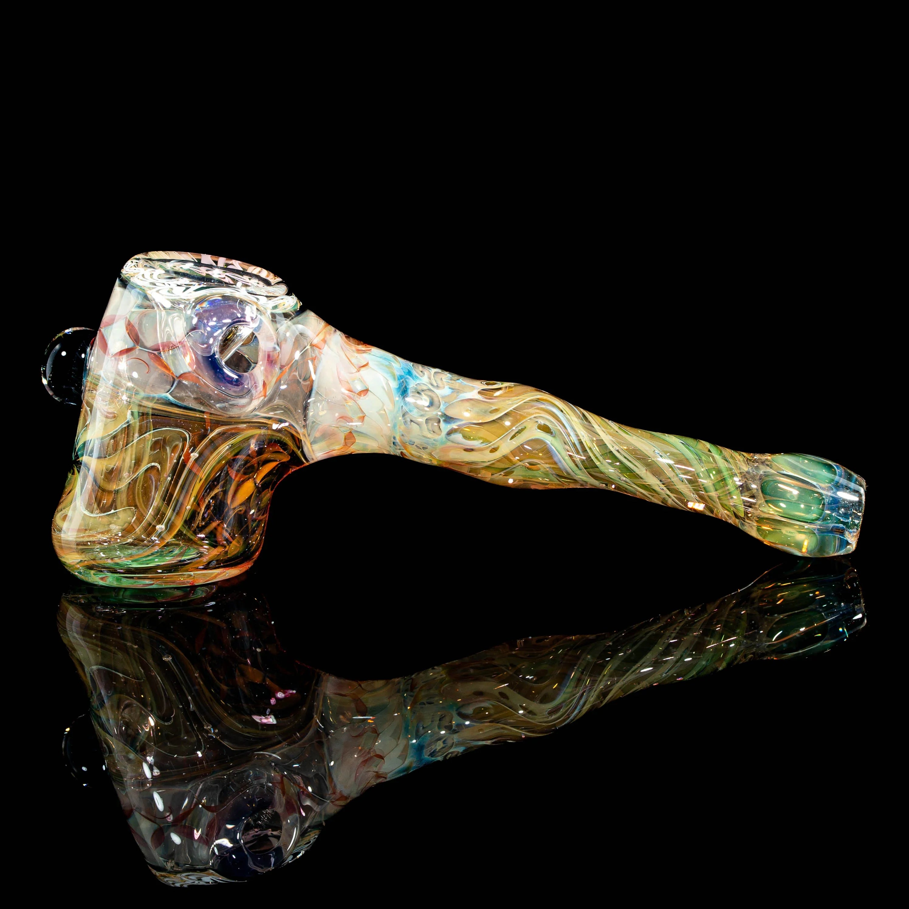 Hand-blown heady glass pipe with colorful swirls on a black reflective surface