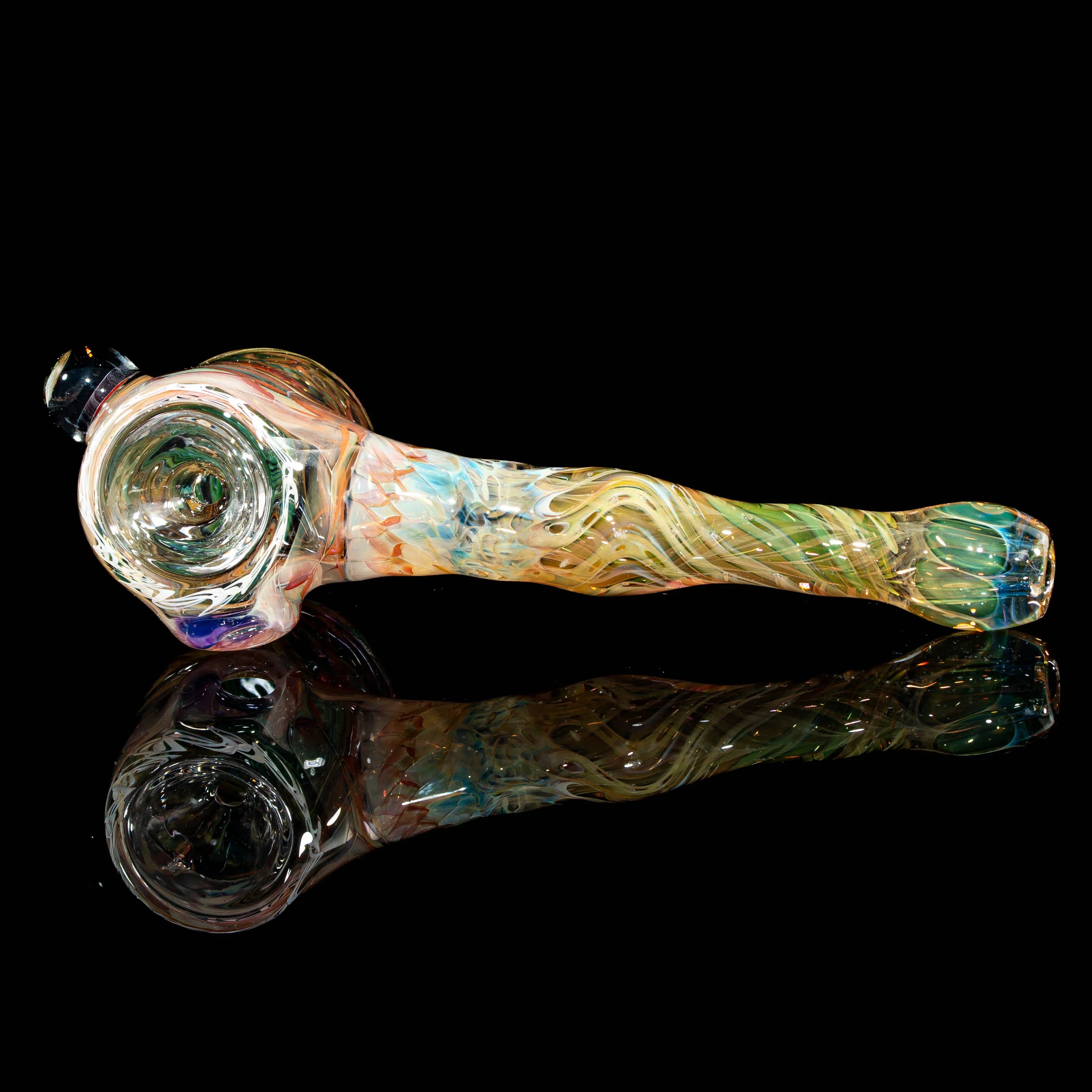 Heady glass hand pipe with colorful swirled patterns and reflective black background
