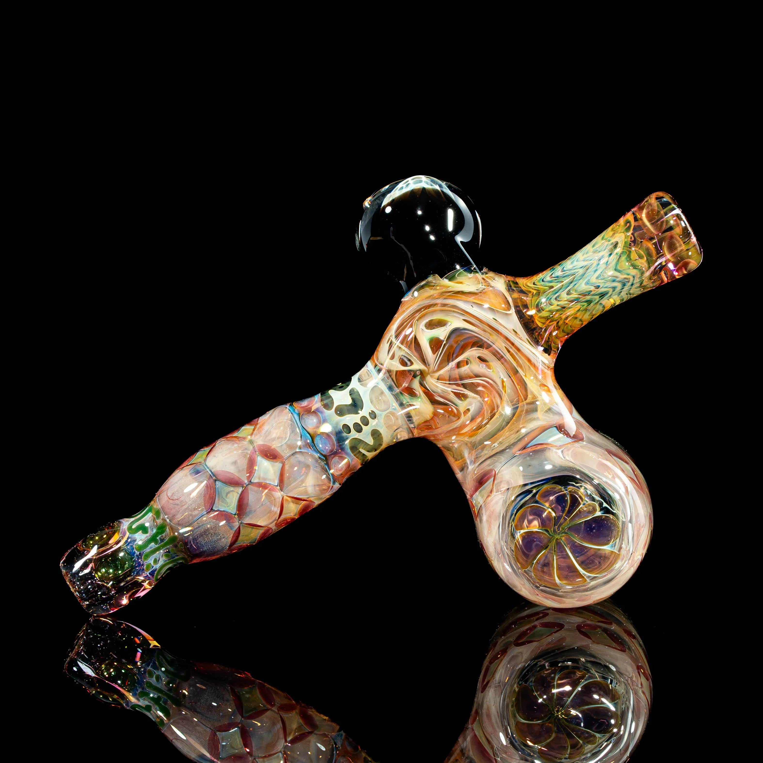 Heady glass hand pipe with intricate colorful swirls and patterns on a black background