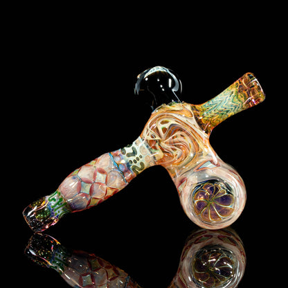 Heady glass hand pipe with intricate colorful swirls and patterns on a black background