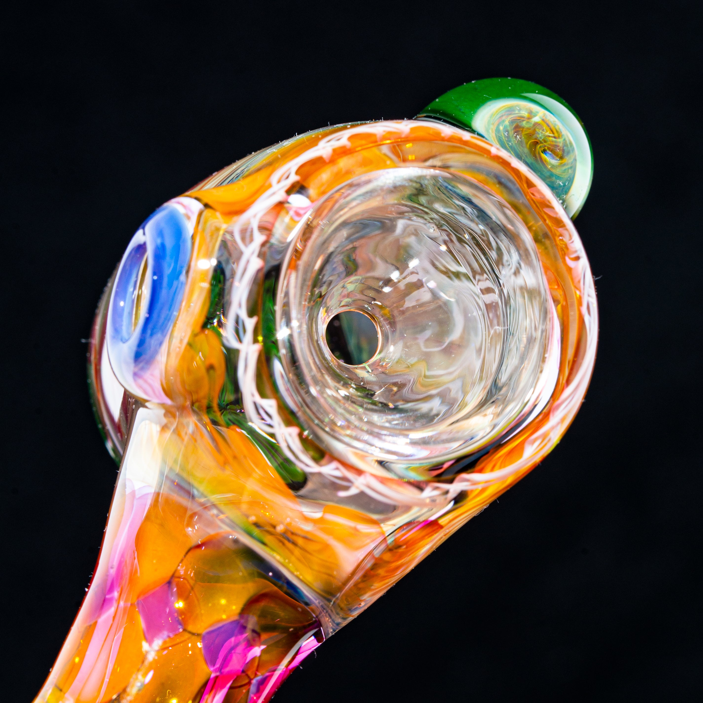 Close-up of colorful heady glass pipe with vibrant swirls and mushroom detail