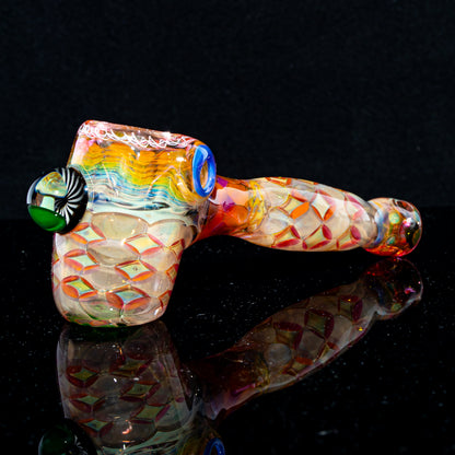 Colorful hand-blown glass hammer pipe with intricate patterns and textured details.