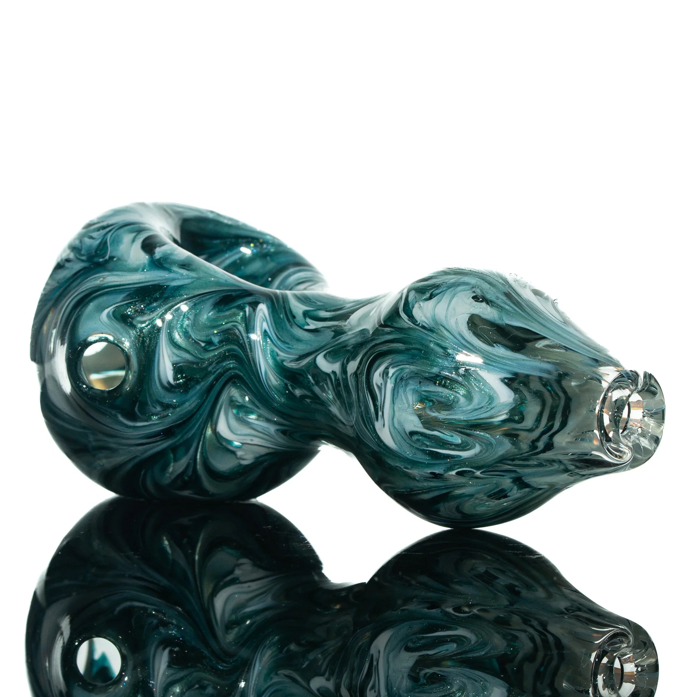 Blue Stardust glass pipe with white swirl design on reflective surface