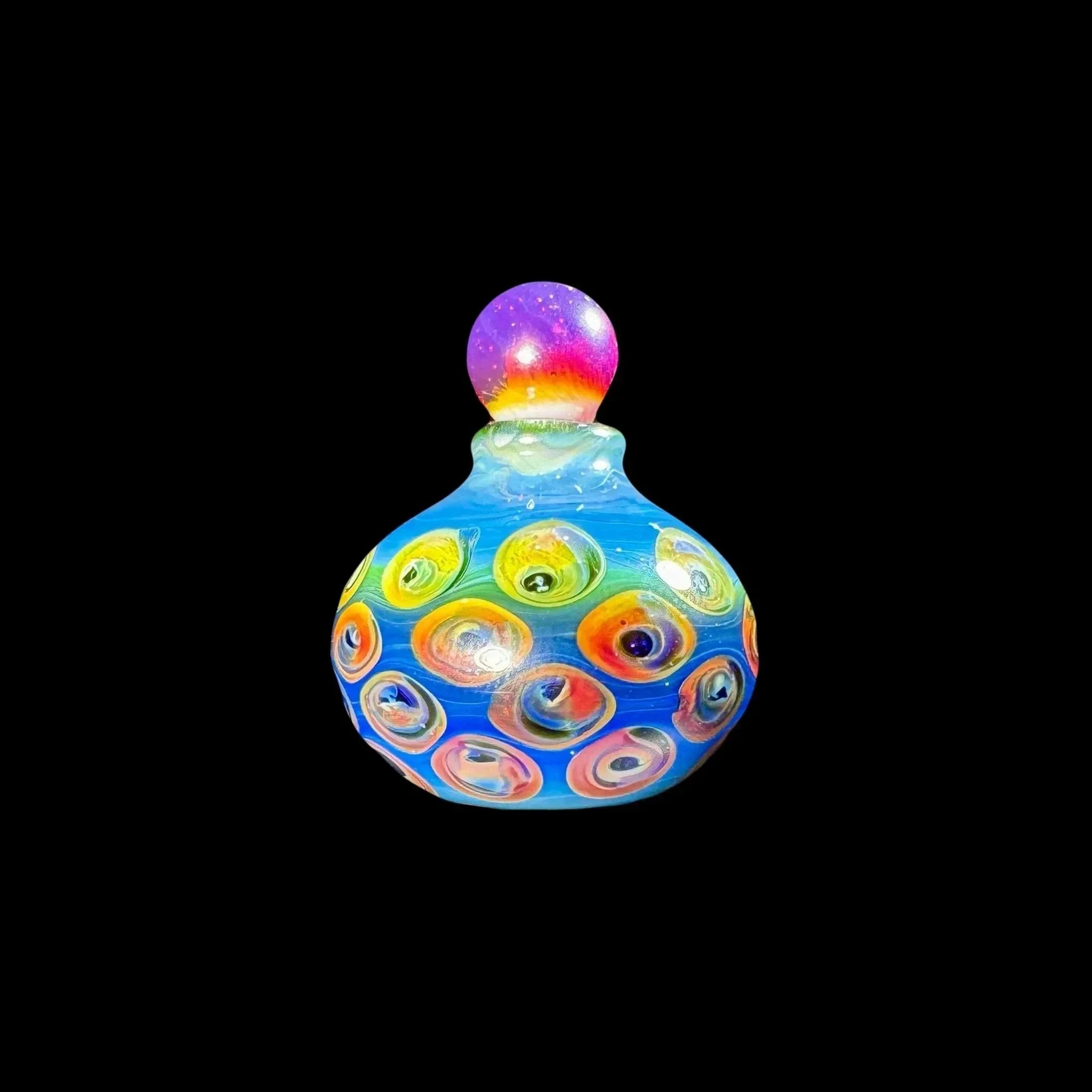 Colorful heady glass jar with vibrant swirling patterns and a rainbow stopper on black background.