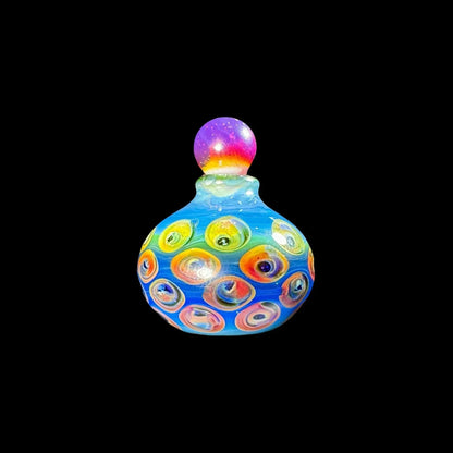 Colorful heady glass jar with vibrant swirling patterns and a rainbow stopper on black background.